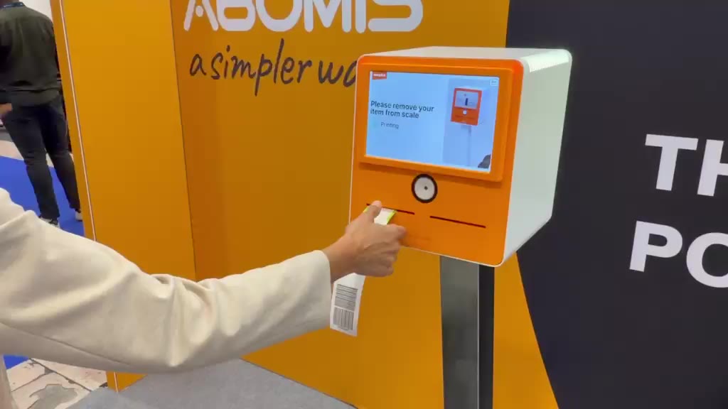 A passenger taking the printed bag tag from TAGROP